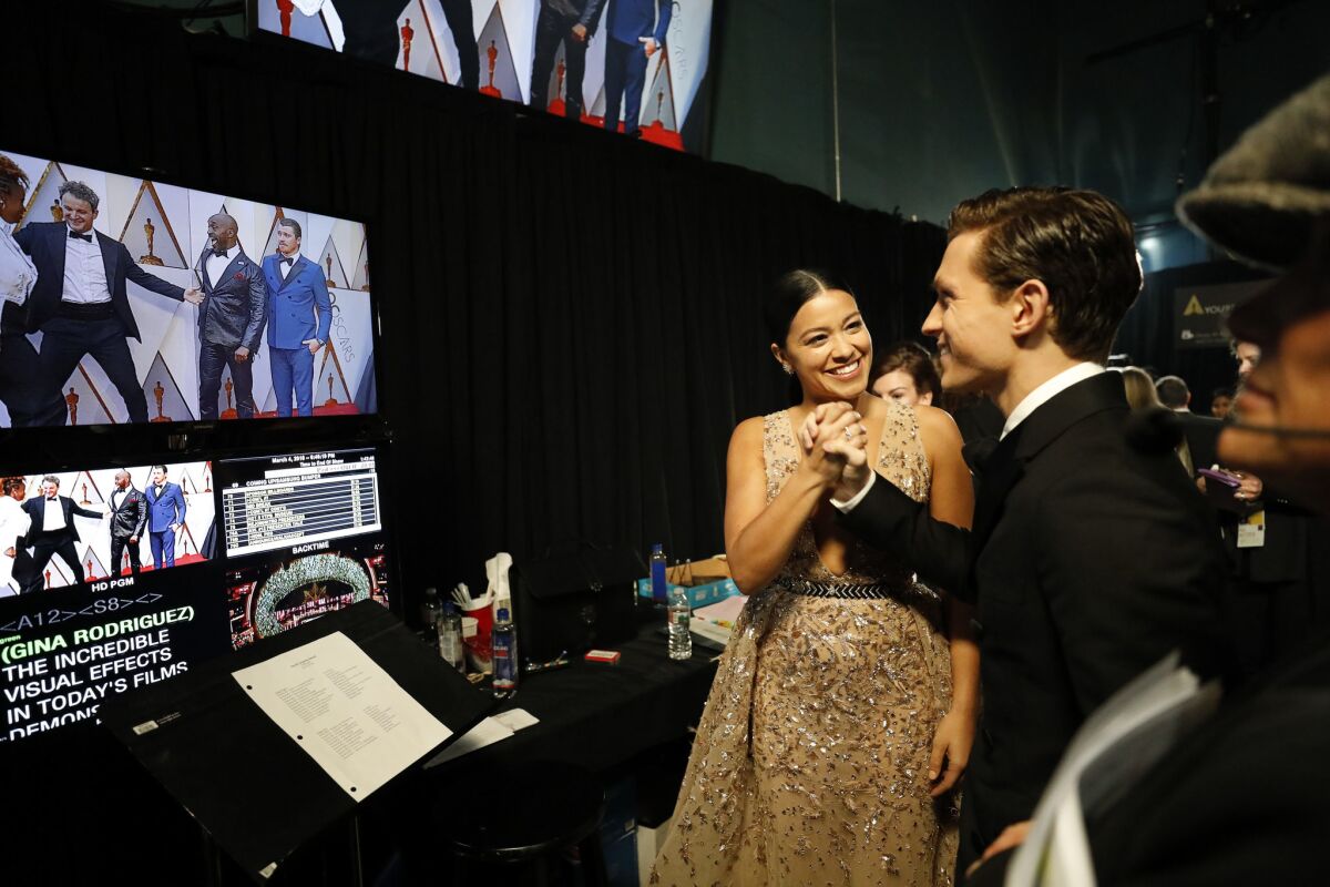 Presenters Gina Rodriguez and Tom Holland backstage at the 90th Academy Awards.