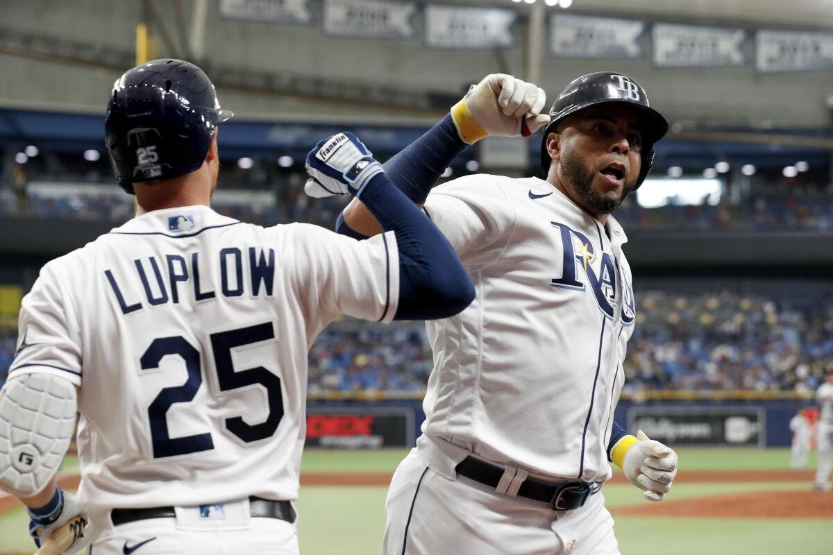 Tampa Bay Rays' Nelson Cruz, right, celebrates with teammate Jordan Luplow after hitting a home run against the Minnesota Twins during the fourth inning of a baseball game on Saturday, Sept. 4, 2021, in St. Petersburg, Fla. (AP Photo/Scott Audette)
