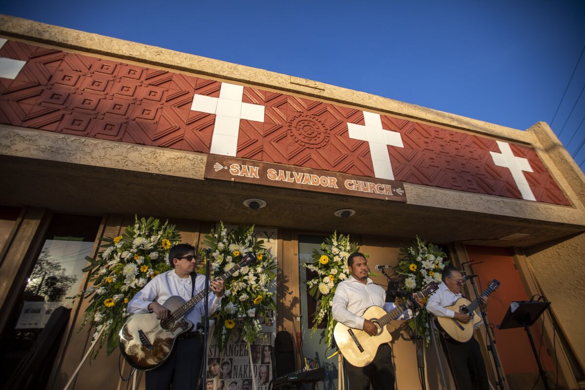 A guitar trio plays before a wake for Tom Rivera.