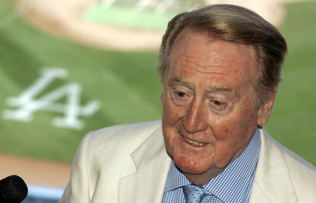 Vin Scully spends his birthday at home reading a book.
