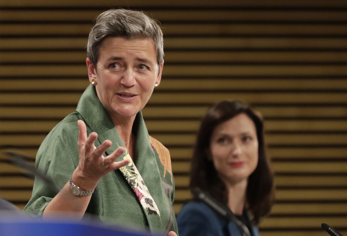 European Commission Vice-President Margrethe Vestager, left, and European Innovation Commissioner Mariya Gabriel participate in a media conference on the digital education action plan at EU headquarters in Brussels, Wednesday, Sept. 30, 2020. (Olivier Hoslet, Pool via AP)