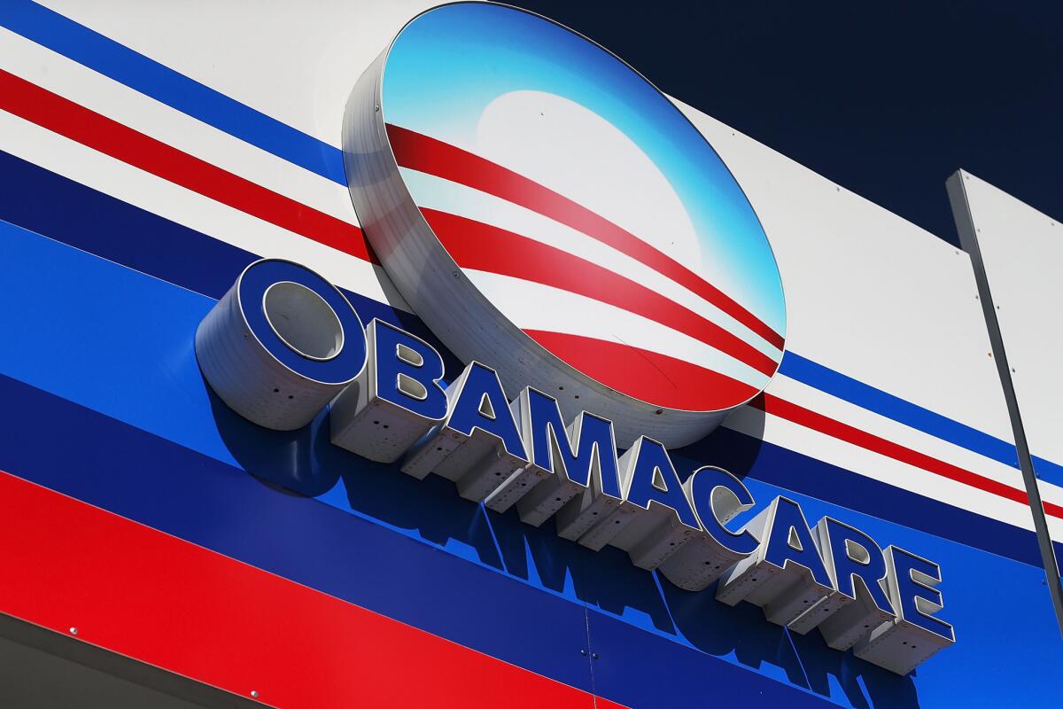 An Obamacare sign is seen outside of an insurance company office on Dec. 15 in Miami, Fla.