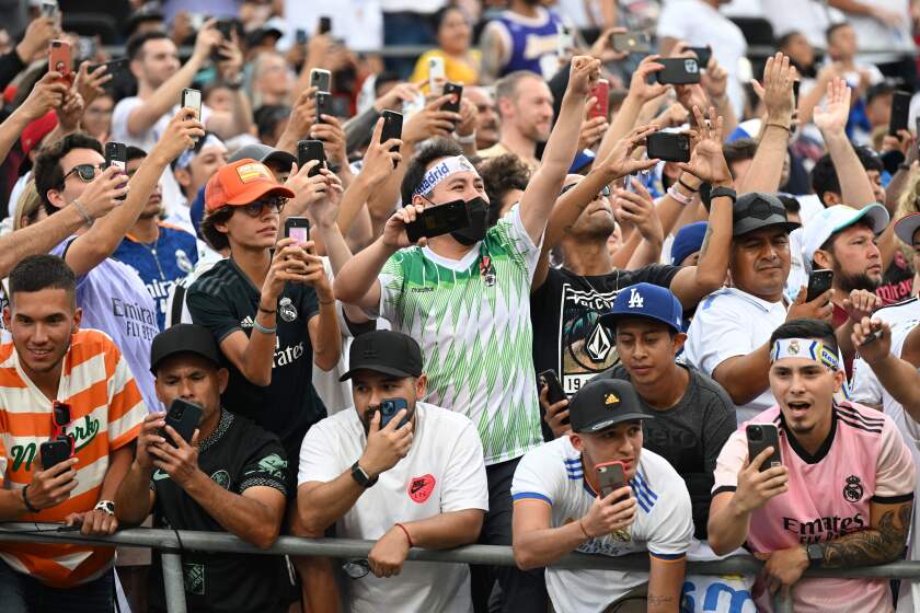 Fans cheer during an international friendly soccer match between Real Madrid and Juventus at the Rose Bowl.