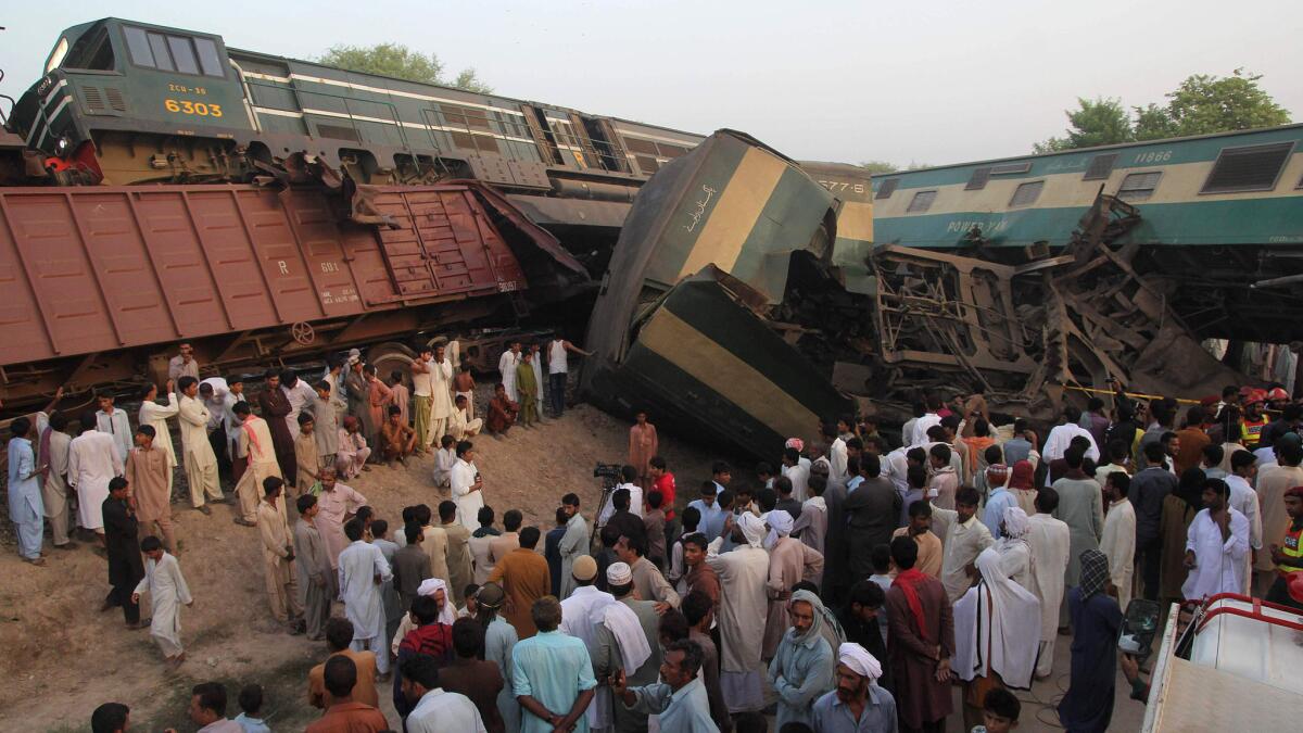 Residents gather at the site of the train crash outside Multan, Pakistan.