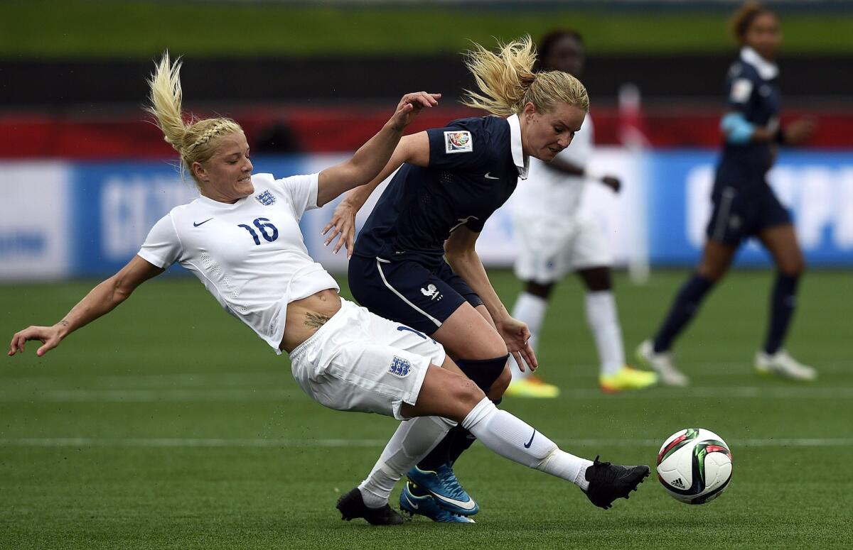 France's Amandine Henry, right, is tackled by England's Katie Chapman during a Group F match at the women's World Cup in Moncton, New Brunswick.