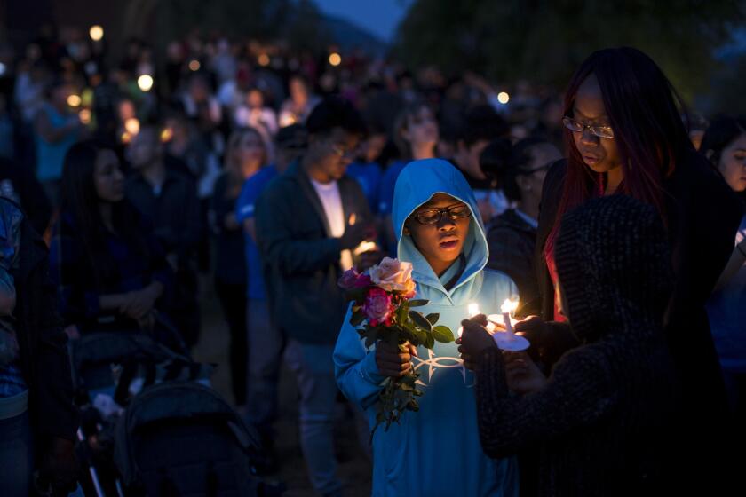 North Park student Elijah Beaven attends a candlelight prayer vigil with his mother, Laura Beaven.