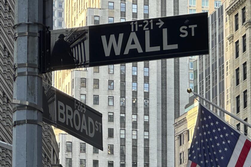 A sign at the intersection of Broad Street and Wall Street is shown on Tuesday, July 16, 2024, in New York. Wall Street is logging tiny gains early as earnings season revs up ahead of the release of U.S. retail sales data that could influence a decision by the Federal Reserve on interest rates. (AP Photo/Peter Morgan)