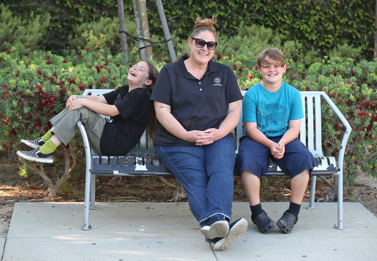 Allison Cuff with Lexy and Nathan, from left, at their apartment park in Huntington Beach.