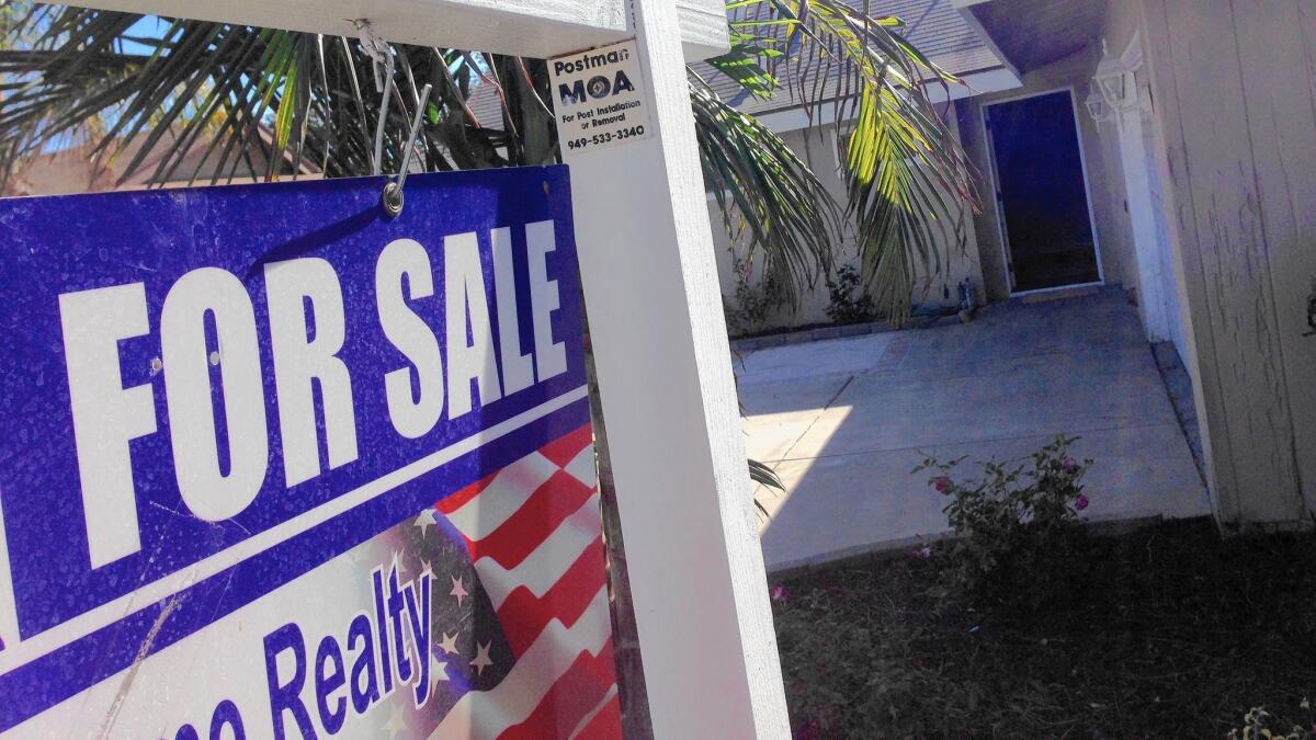 The California Assn. of Realtors is predicting prices will grow 5.2% statewide next year, the slowest pace since 2011. Above, a home for sale in Huntington Beach.