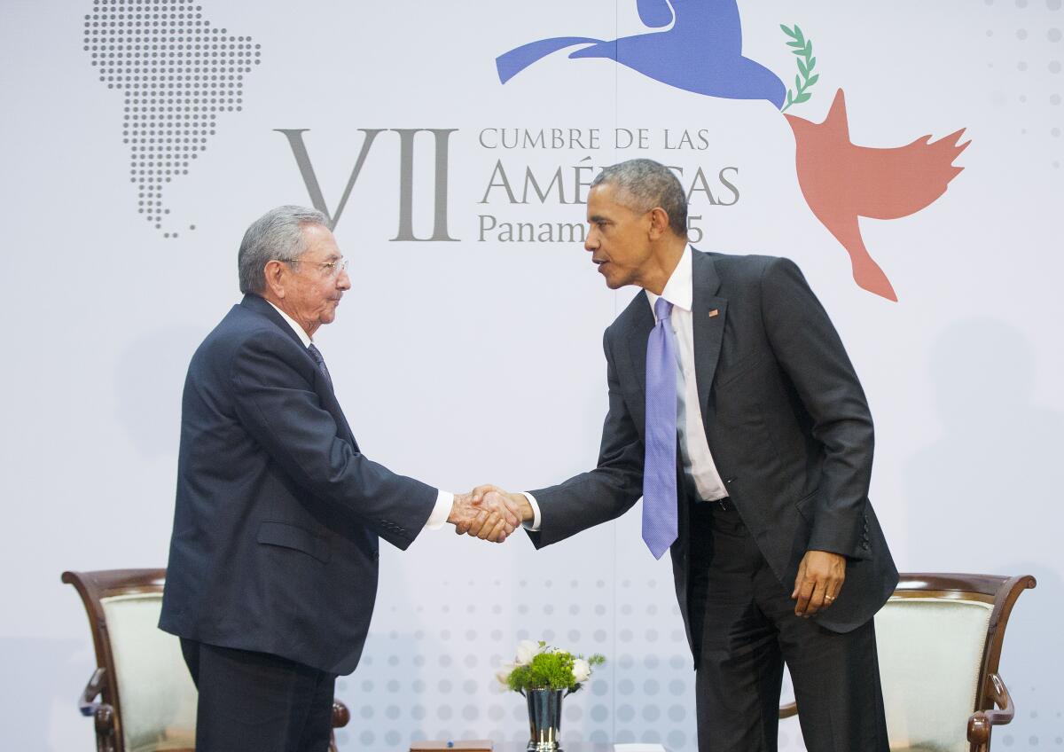 Barack Obama and Cuban President Raul Castro shake hands