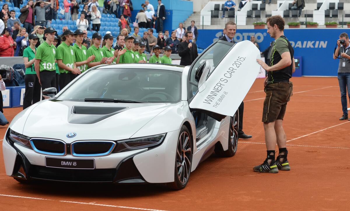 Andy Murray inspects his new car after defeating Philipp Kohlschreiber to win the final match at the BMW Open.