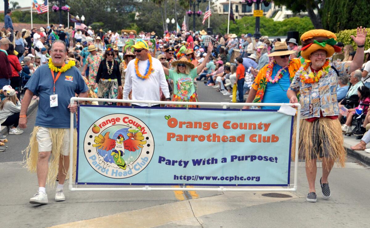 First timers in the Balboa Island Parade march with a banner for the Orange County Parrothead Club.