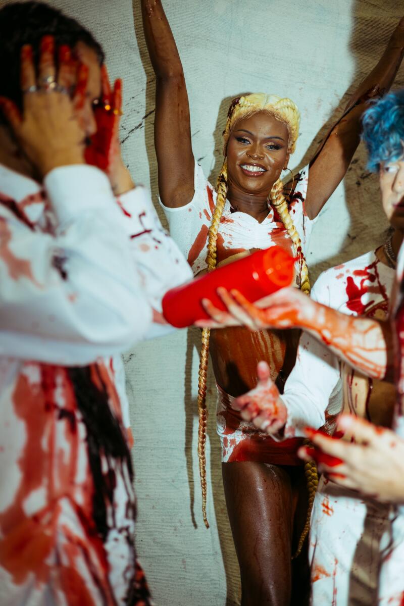 Symone and the rest of the House of Avalon crew bathe in fake blood for a Halloween-themed performance at Precinct.