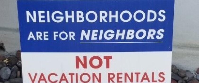 A yard sign speaks to the feelings that many community members have against short-term vacation rentals.