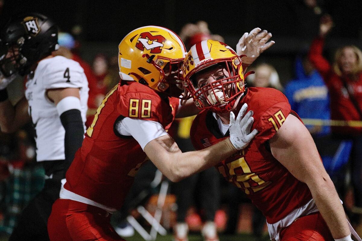 Mission Viejo's Jack Matranga, right, gets a hug from teammate Grant Nichols after his touchdown.