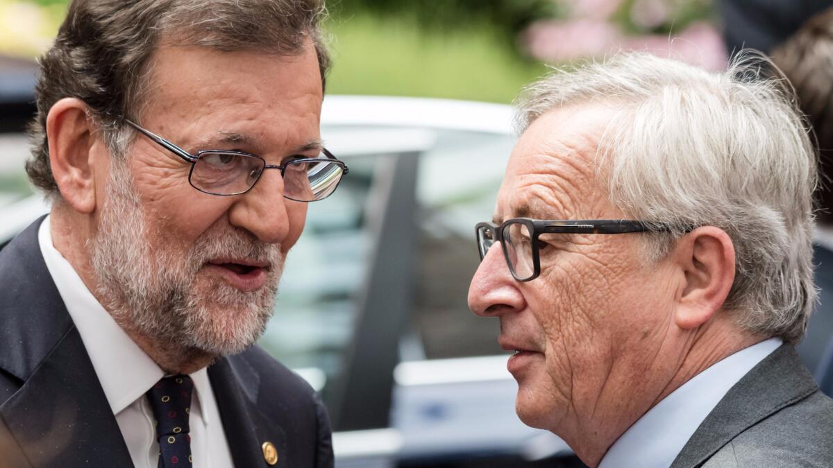 Spanish Prime Minister Mariano Rajoy, left, speaks with European Commission President Jean-Claude Juncker after an EU summit in Brussels on Wednesday, June 29, 2016.