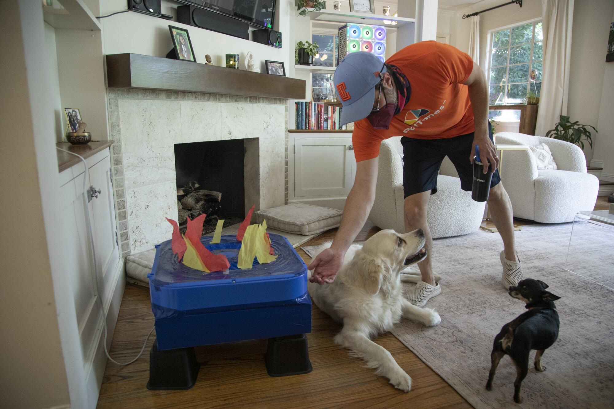 Alex LeVine's most basic Corsi-Rosenthal box, made of a box fan and furnace filter, with art paper "flames." 