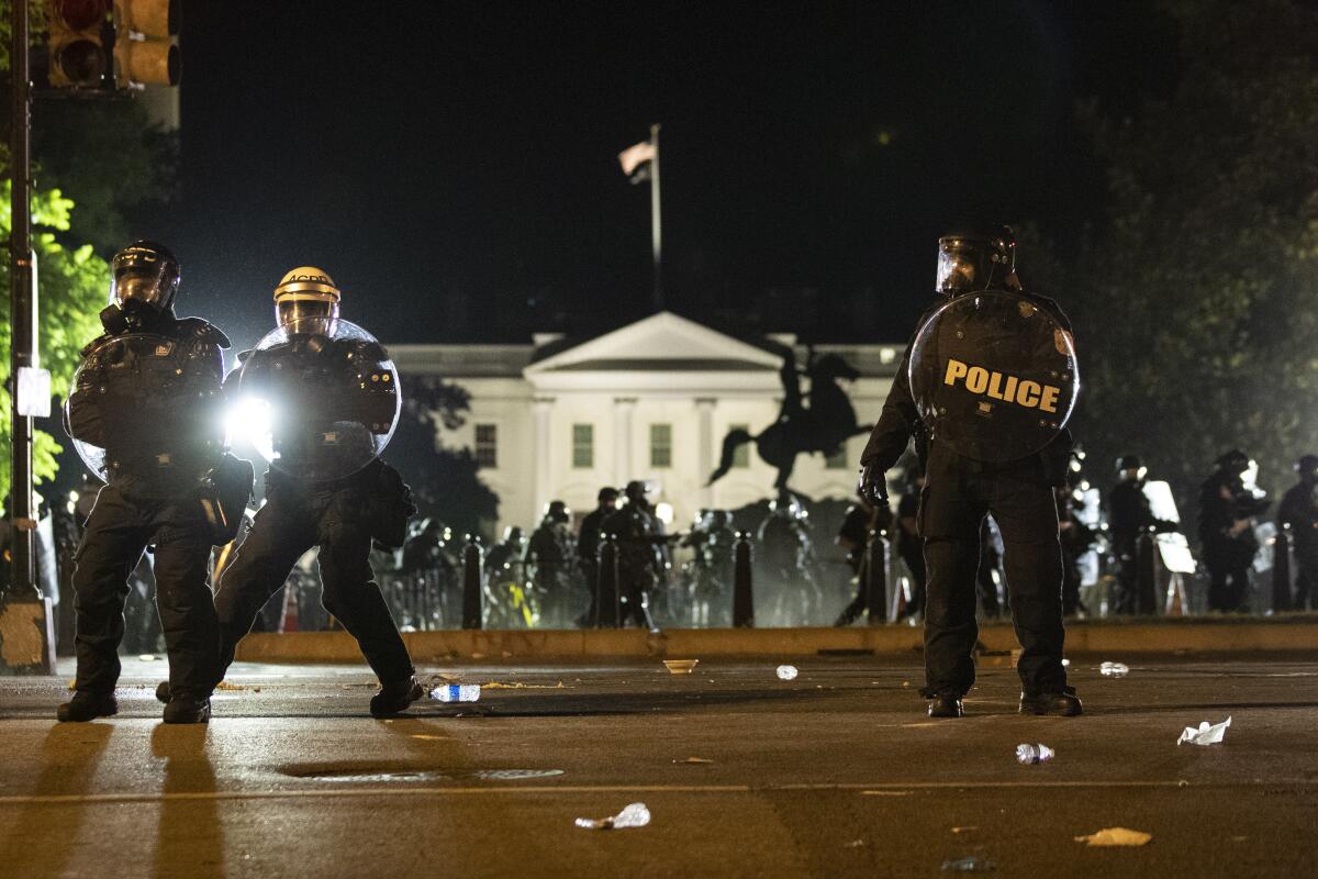 Police form a line as demonstrators gather to protest the death of George Floyd on Sunday near the White House in Washington. 