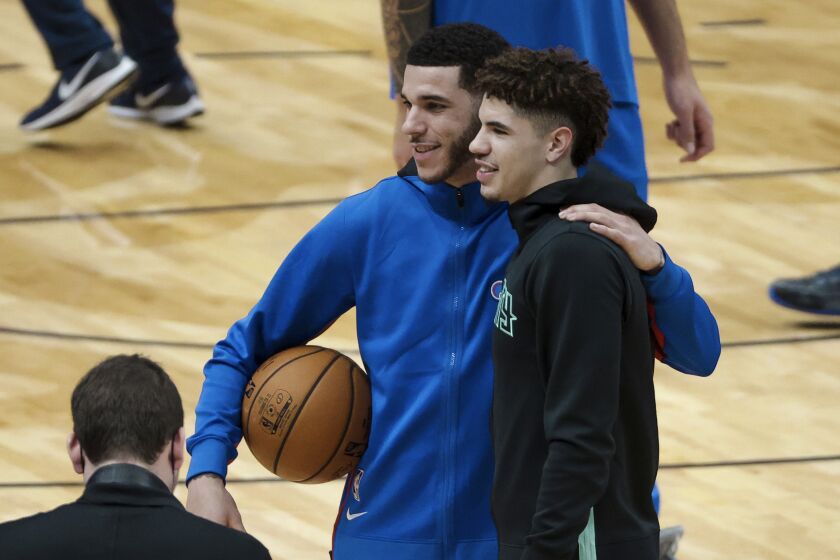 Lonzo, left, and LaMelo Ball pose for a photo before their first NBA game playing each other other on Jan. 7, 2020.