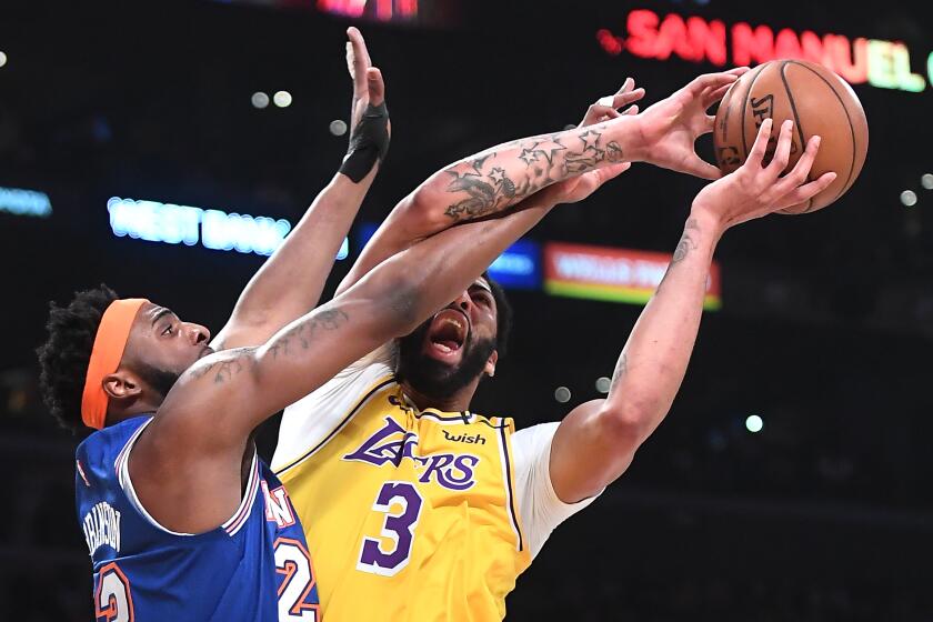 LOS ANGELES, CALIFORNIA JANUARY 7, 2020-Lakers Anthony Davis is fouled by Knicks Mitchell Robinson in the 1st quarter at the Staples Center Tuesday. (Wally Skalij/Los Angerles Times)