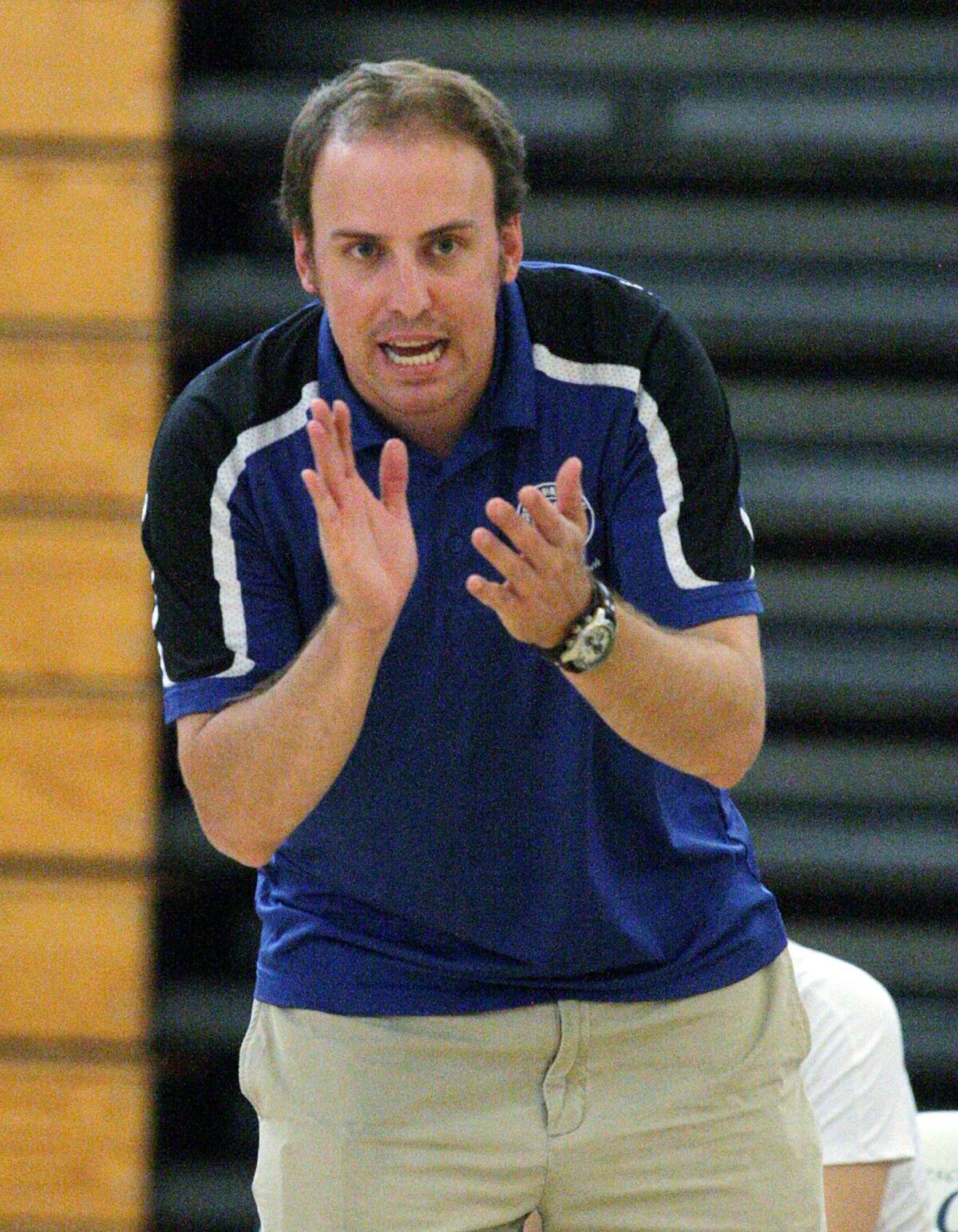 Burbank High girls' volleyball coach Kyle Roach applauds during a game against Crescenta Valley on Tuesday, September 30, 2014. Roach was arrested in June 2015 for having sexual relations with a former student and anonymously soliciting nudes from two volleyball players.