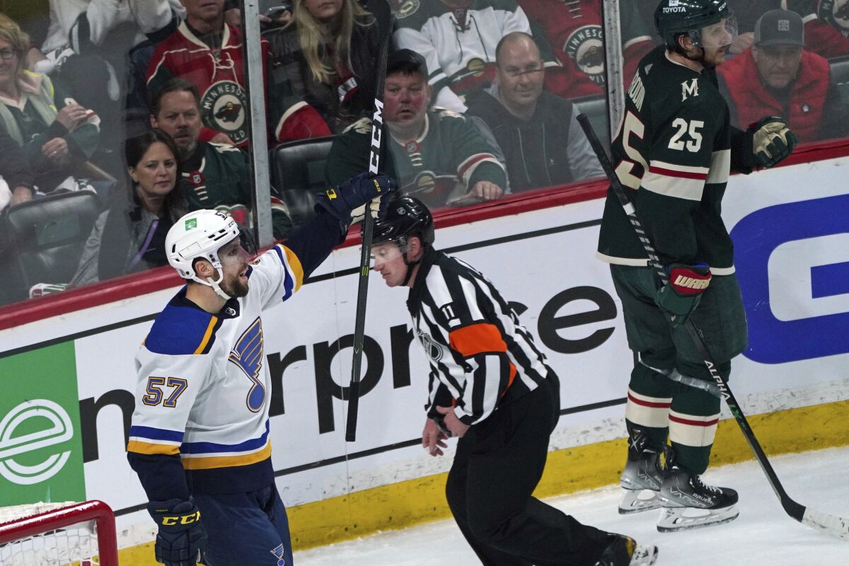 St. Louis Blues' David Perron (57) celebrates his goal against Minnesota Wild goalie Marc-Andre Fleury (29) in the second period of Game 1 of an NHL hockey Stanley Cup first-round playoff series, Monday, May 2, 2022, in St. Paul, Minn. Perron also scored a goal in the first period. (AP Photo/Jim Mone)