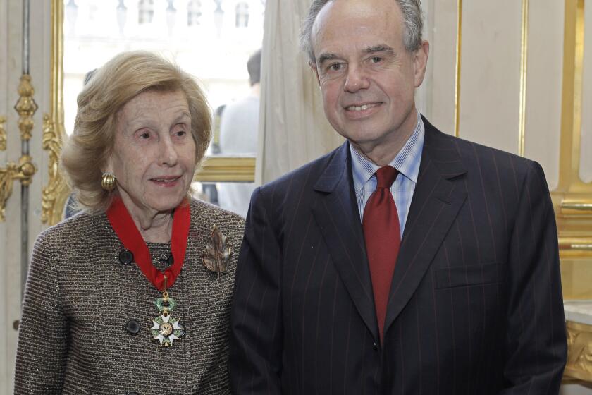 U.S billionaire media proprietor Anne Cox Chambers, left, poses with French Culture Minister Frederic Mitterand after being awarded "Commandeur de la LTgion d'Honneur" ( Commander in the Legion of Honor) at the Culture Ministry, in Paris in 2009