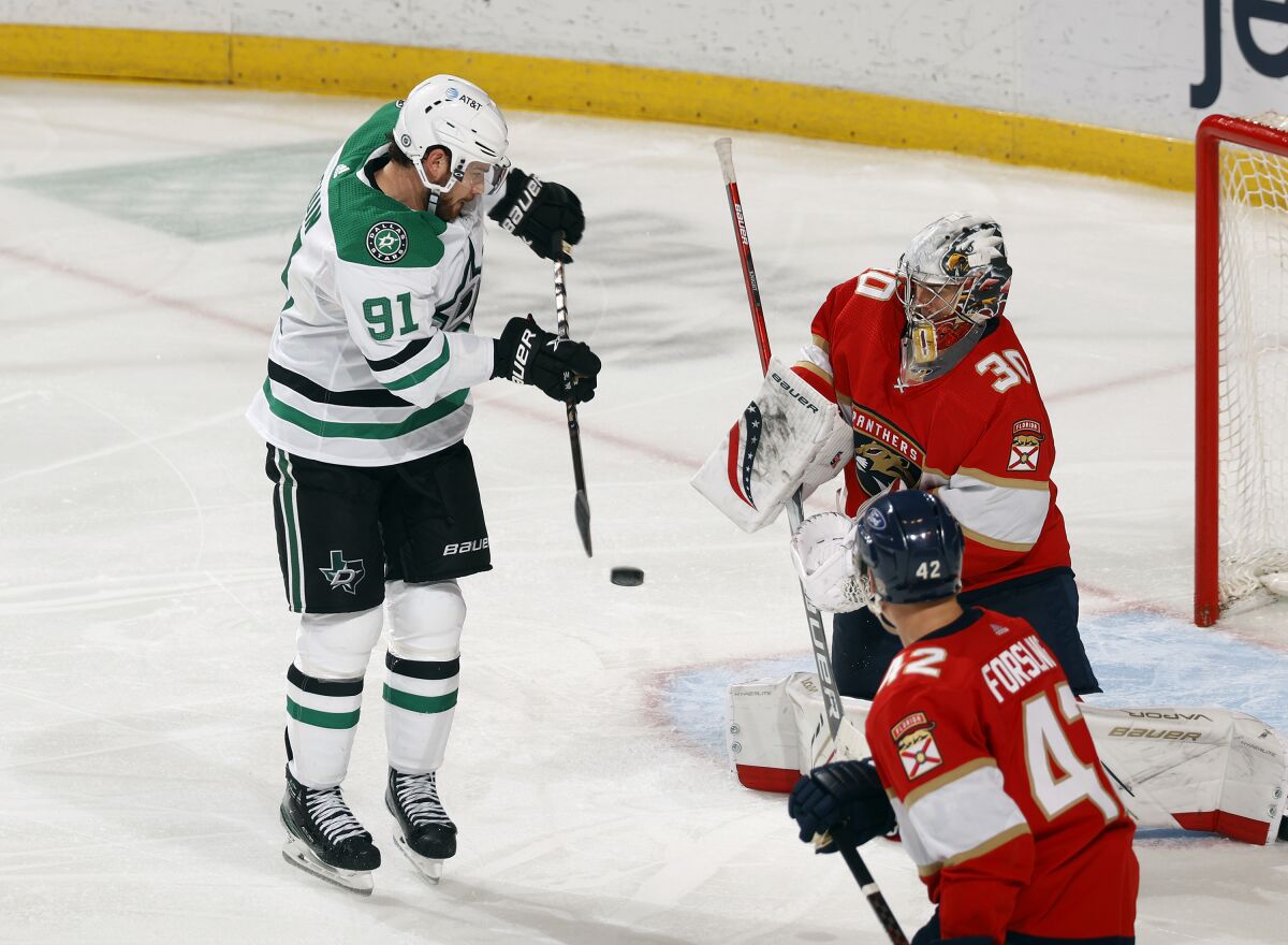 File-This May 3, 2021, file photo shows Dallas Stars center Tyler Seguin (91) scoring a game-tying goal past Florida Panthers goaltender Spencer Knight (30) during the third period of an NHL hockey game, in Sunrise, Fla. Six months and a day after his hip surgery, during a span when he also had arthroscopic surgery on his right knee, Seguin returned to the ice for the Dallas Stars by playing twice as long as planned and scoring a game-tying goal that forced overtime Monday, May 3, 2021, at Florida.(AP Photo/Joel Auerbach, File)