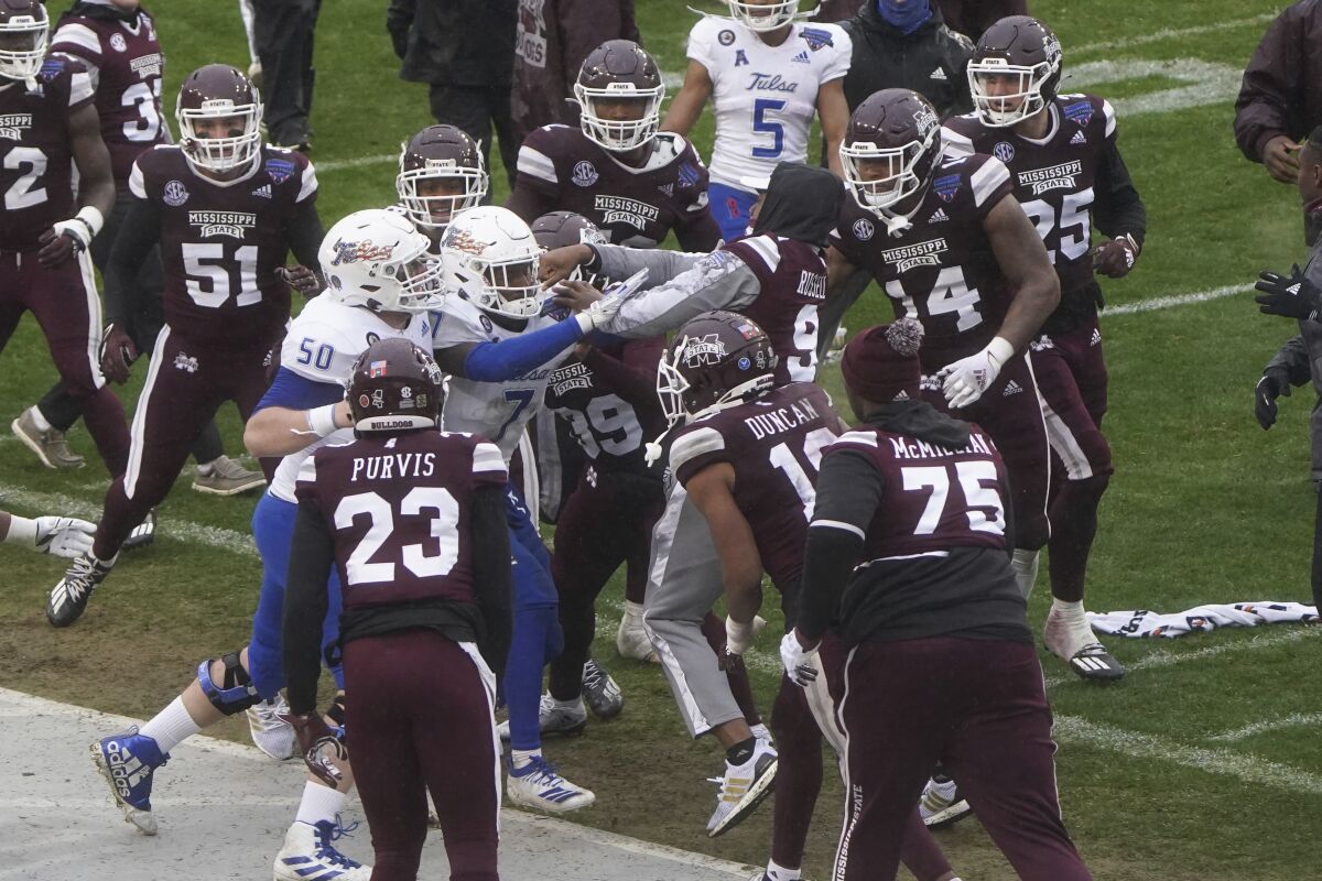 Members of Tulsa and Mississippi State fight after time runs out in Armed Forces Bowl.