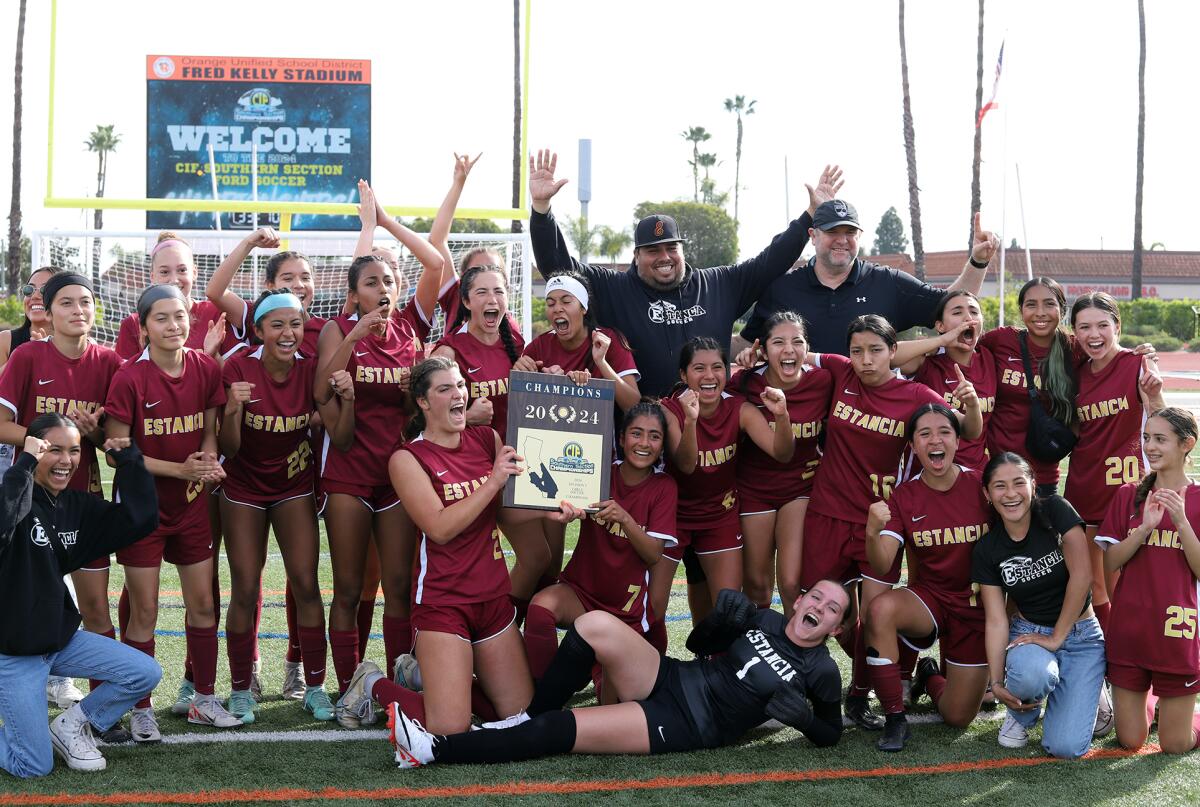 The Estancia High School girls' soccer team and coaches pose with the CIF Southern Section Division 5 title Saturday.