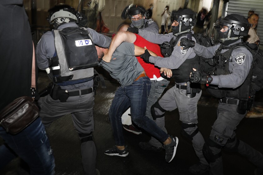 Israeli police officers clash with Palestinian protesters near Damascus Gate just outside Jerusalem's Old City, Sunday, May 9, 2021. (AP Photo/Ariel Schalit)