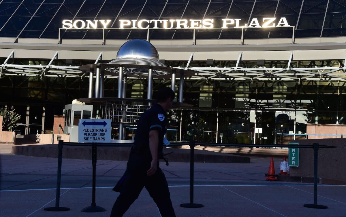 A security guard walks past the entrance to Sony Pictures Plaza in Los Angeles.