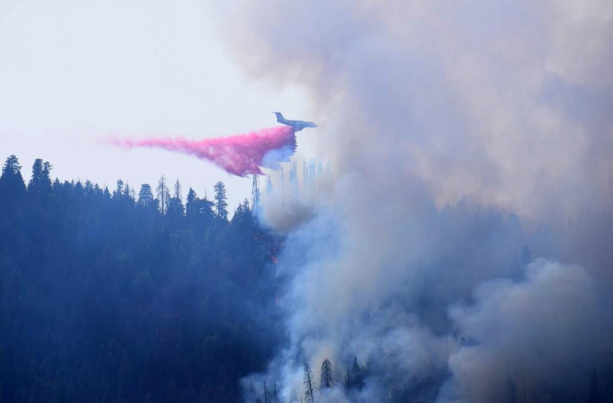 A plane drops retardant on a wildfire burning in Sequoia and Kings Canyon National Park.