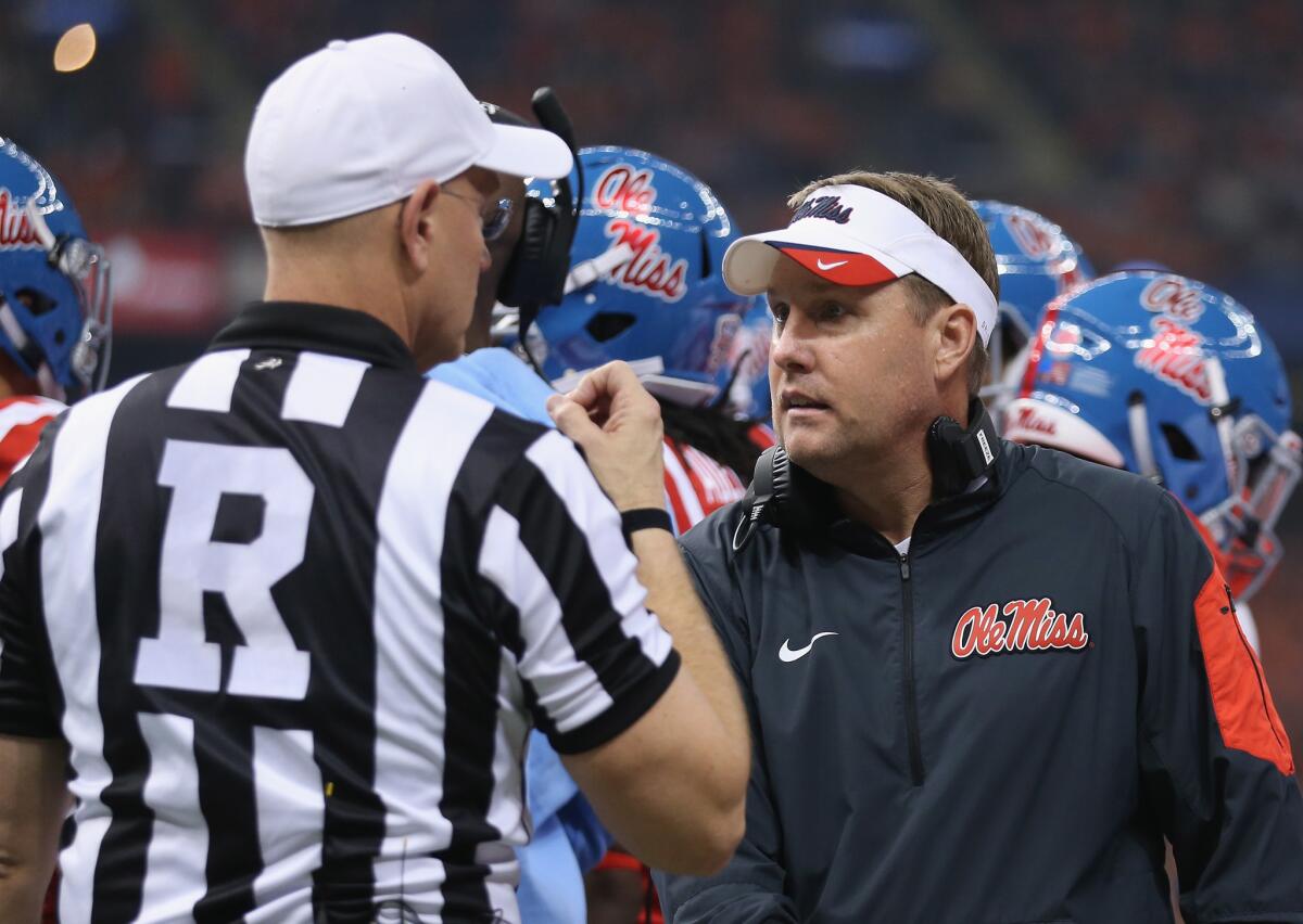 Mississippi Coach Hugh Freeze talks with a referee during the first quarter of the Allstate Sugar Bowl against Oklahoma State.