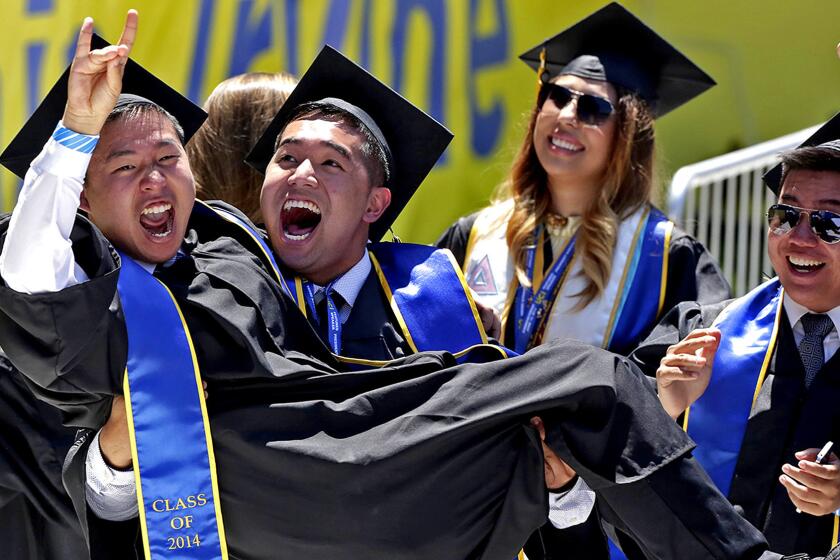 Graduating UC Irvine students show their excitement for President Obama's appearance during the university's 50th commencement ceremony.
