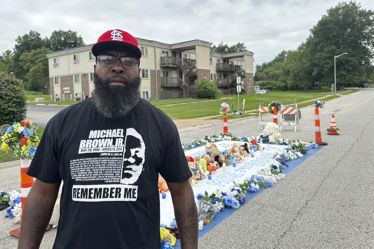 Michael Brown Sr. stands near the memorial to his son in Ferguson, Mo.