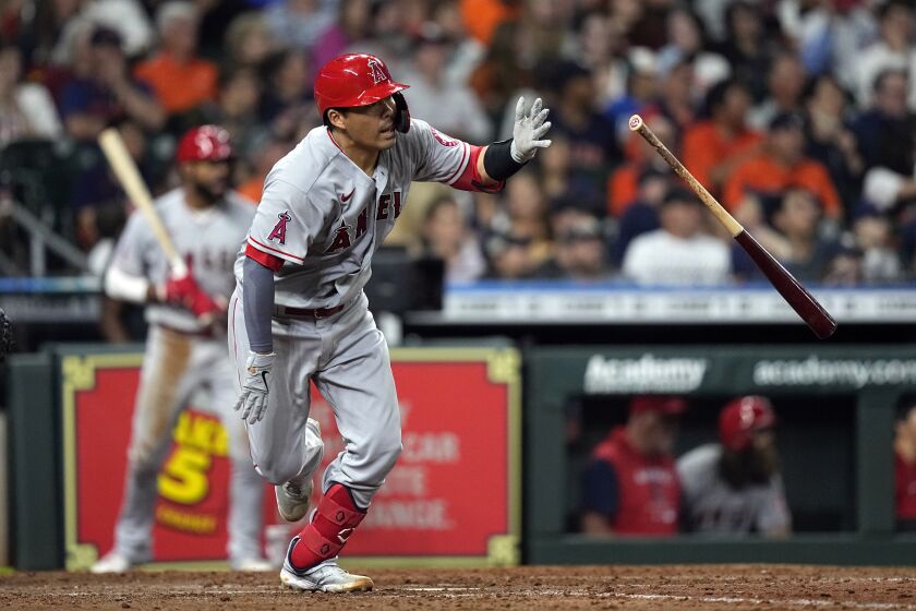 Los Angeles Angels' Kurt Suzuki tosses his bat after hitting a two-run double during the fifth inning of a baseball game against the Houston Astros Tuesday, April 19, 2022, in Houston. (AP Photo/David J. Phillip)