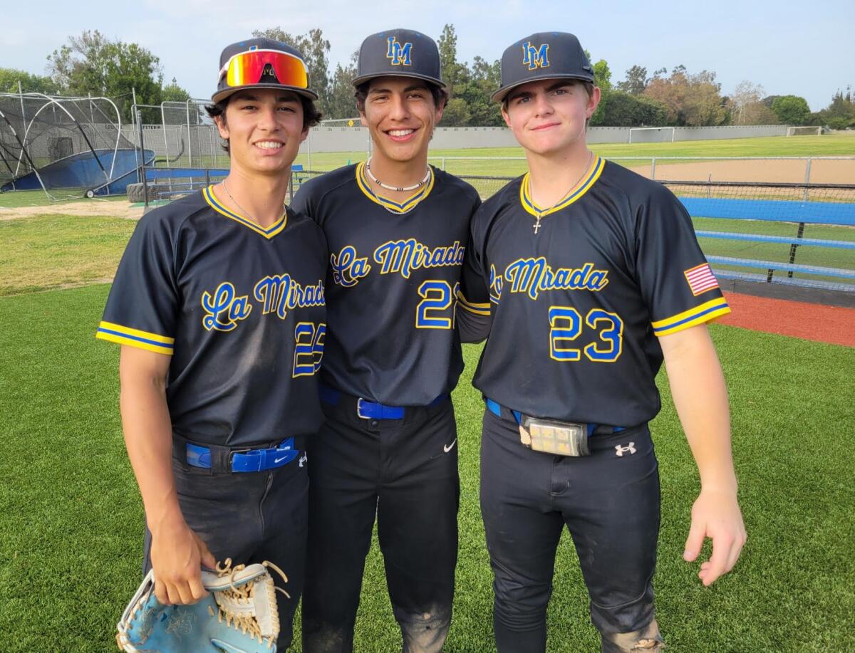 Three baseball players from No. 14 La Mirada High smile for a photo.