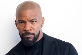 Actor Jamie Foxx looking leaning slightly