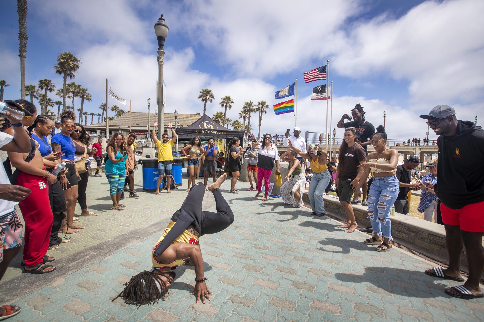 Daniel Kelly dances in front of a crowd at Pier Plaza during "A Great Day in the Stoke" in Huntington Beach on Saturday.