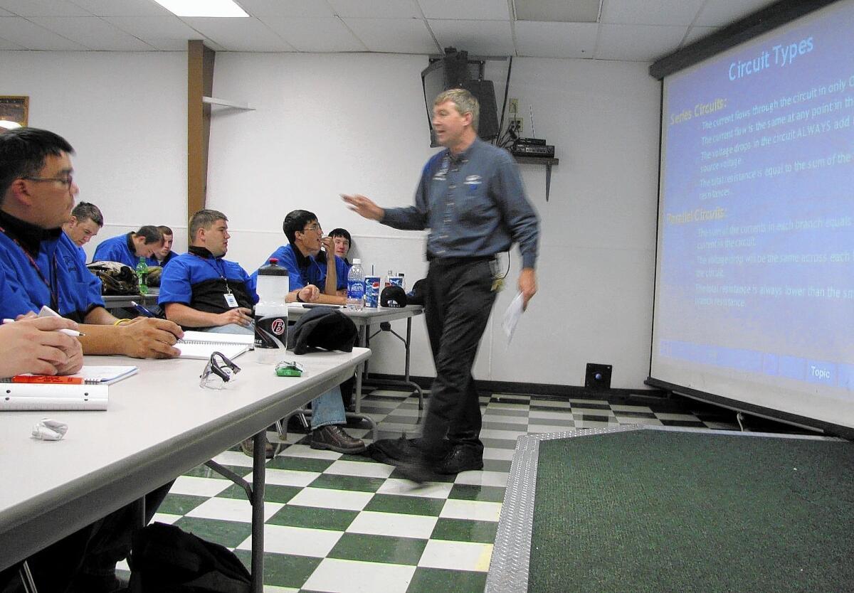 Larry Wostenberg teaches an engine management systems class at the WyoTech technical school campus in Laramie, Wyo., Corinthian College in 2009.