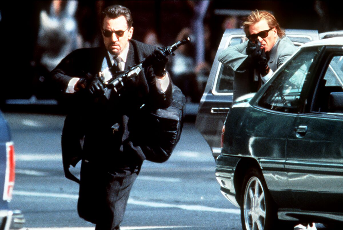 Robert De Niro and Val Kilmer hold guns in a scene from "Heat"