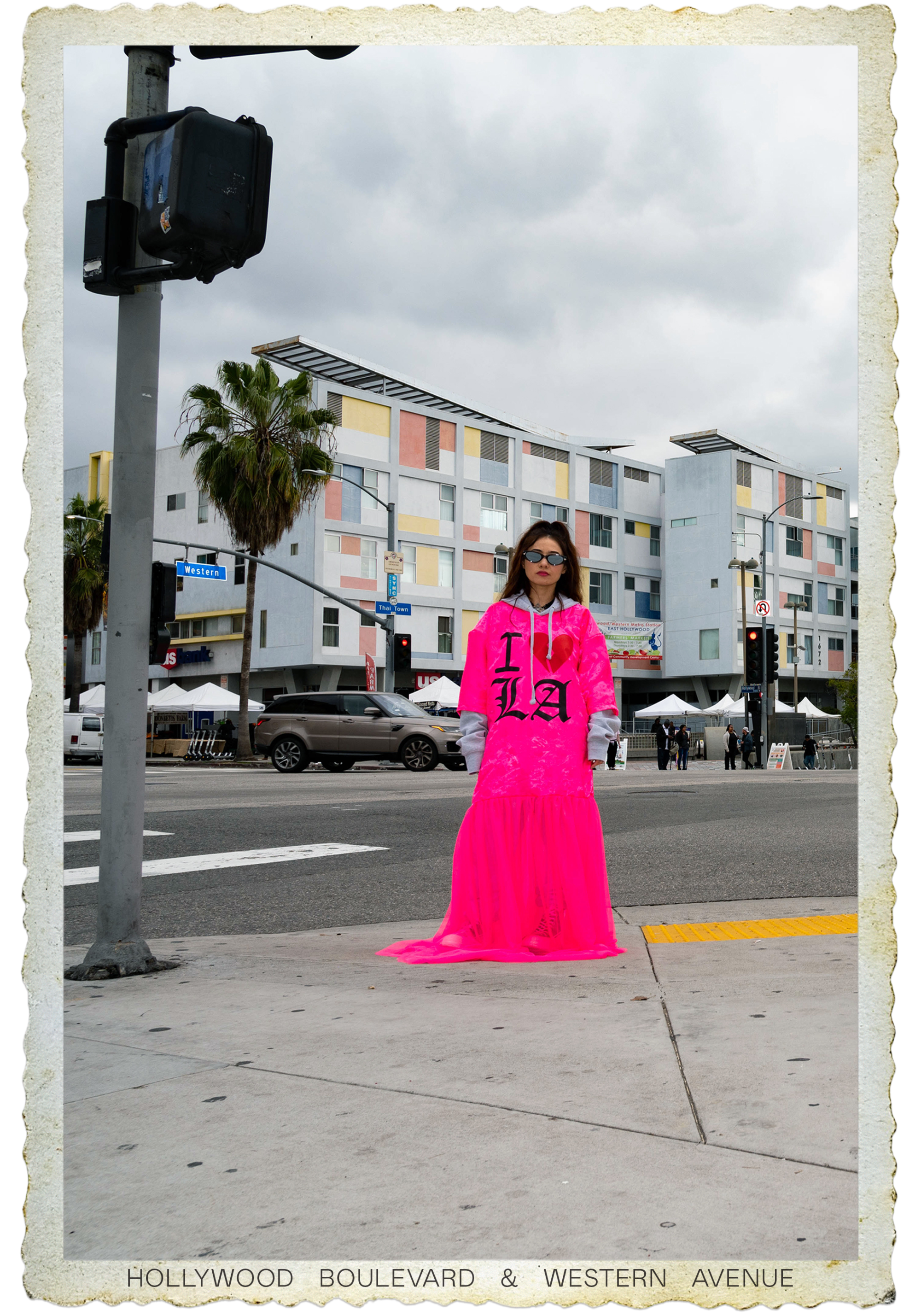 Vally Campbell wears a pink dress at intersection of Hollywood and Western.