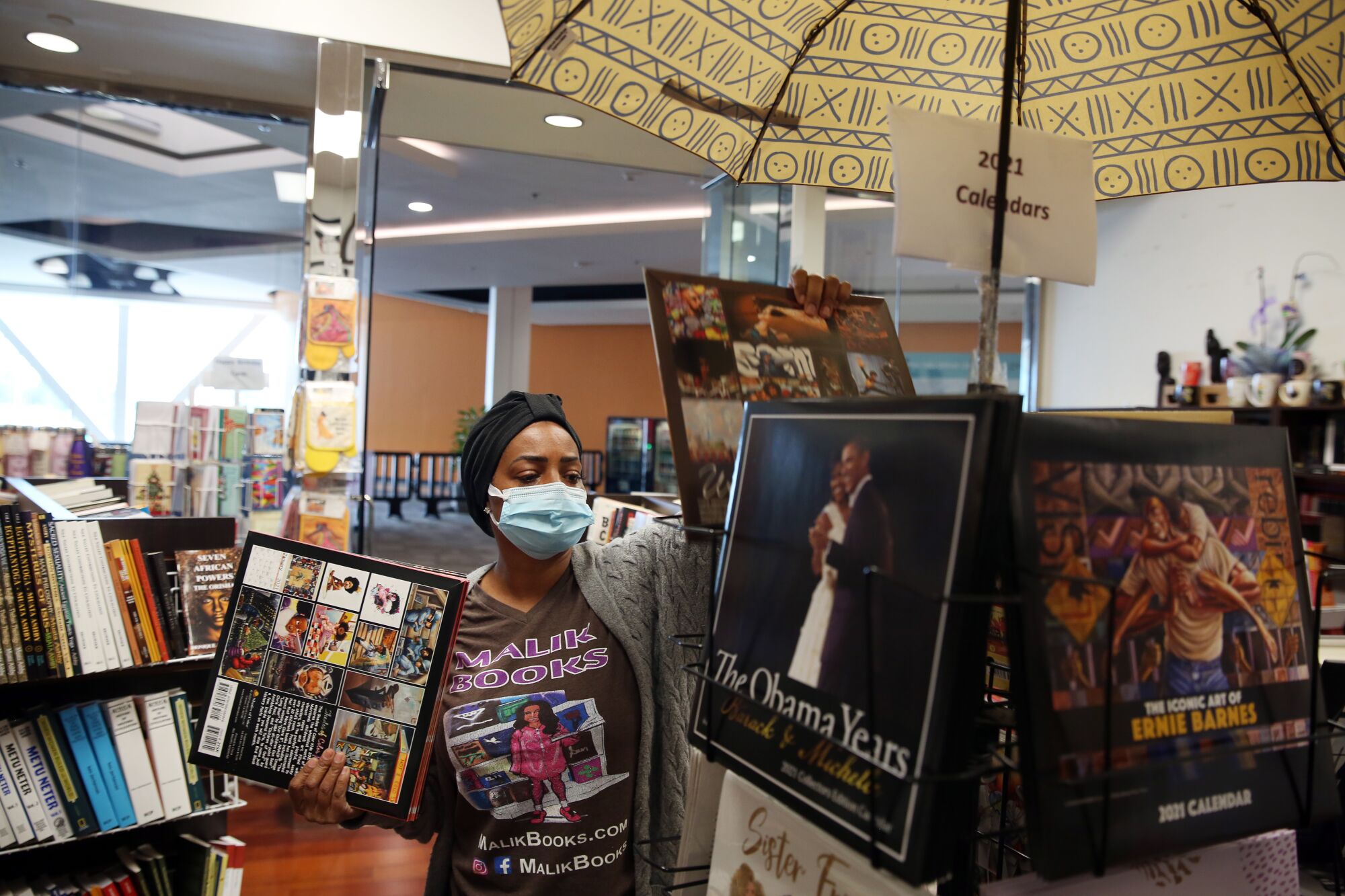 April Muhammad of Malik Books organizes calendars at the shop in Baldwin Hills Crenshaw Plaza.