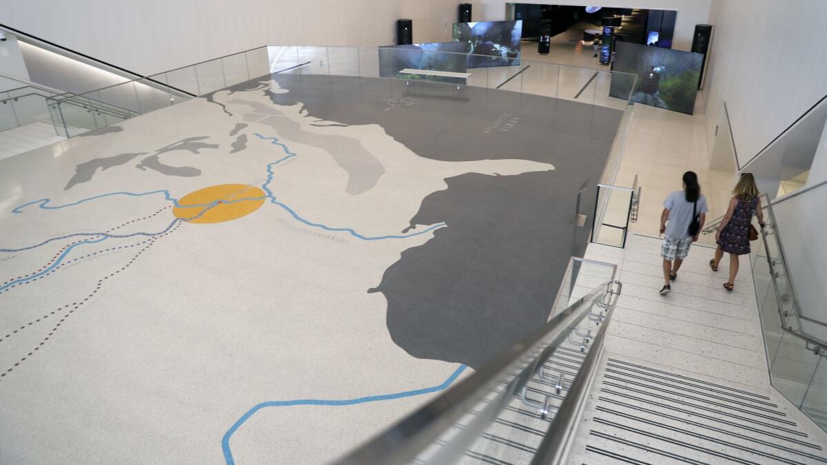 Visitors use a new entrance to the Gateway Arch, where the floor shows a map of U.S. westward migrations.