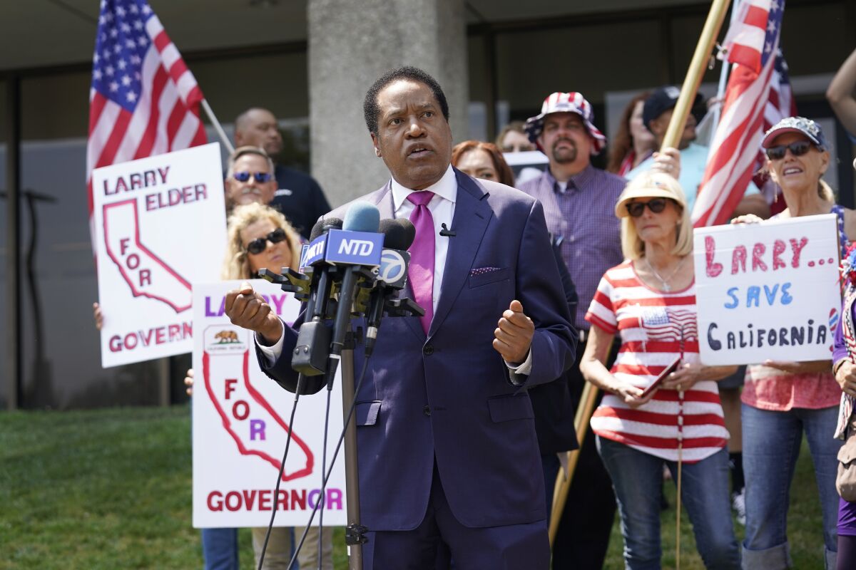 FILE — In this July 13, 2021 file photo radio talk show host Larry Elder speaks to supporters during a campaign stop in Norwalk, Calif. Elder, in his first press conference since announcing his candidacy July 12, told reporters that if he replaces Democratic Gov. Gavin Newsom in the Sept. 14 election any mask or vaccine mandates in place at that time “will be suspended right away.” (AP Photo/Marcio Jose Sanchez, File)
