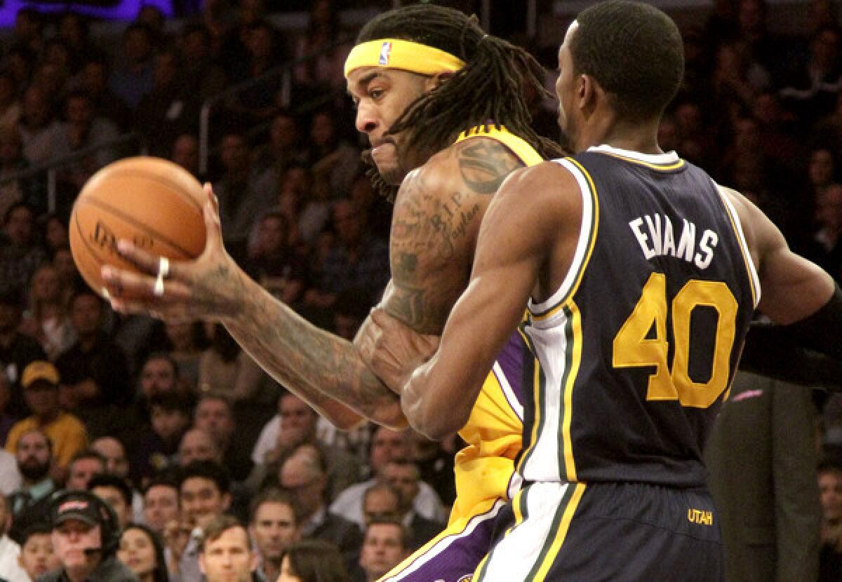 Lakers power forward Jordan Hill works in the post against Jazz forward Jeremy Evans during a game earlier this season at Staples Center.