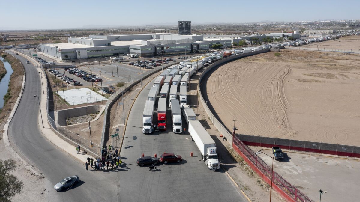 A long line of trucks is seeing stalled at the Zaragoza International Bridge, one of two ports of entry in Ciudad Juarez going into the U.S.on April 12, 2022. The truckers blocked both north and south bound commercial lanes in protest after they have seen prolonged processing times implemented by Gov. Abbott which they say have increased from 2-3 hours up to 14 hours in the last few days. (Omar Ornelas /The El Paso Times via AP)