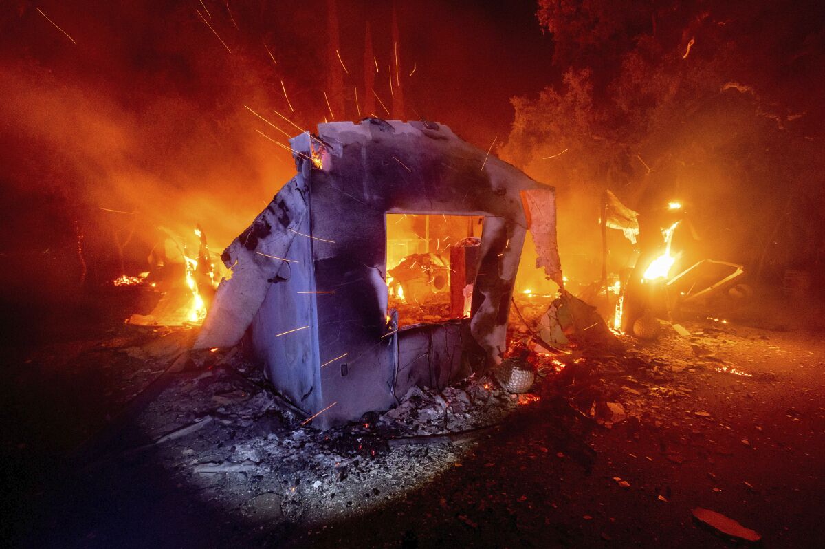 Flames from the LNU Lightning Complex fire consume a home in unincorporated Napa County.