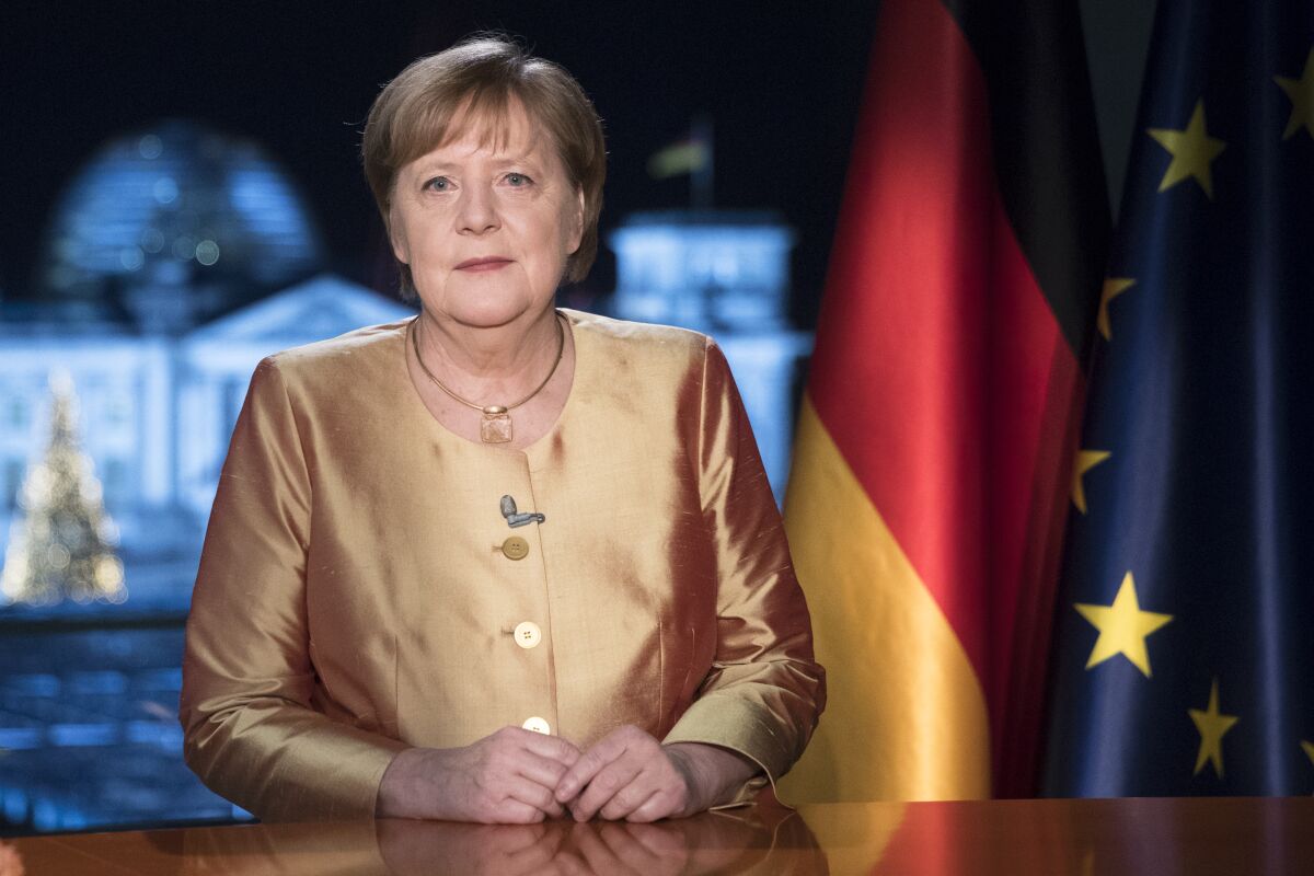EMBARGO - UNTIL DEC. 31 00:00 A.M. CET - FREE FOR THURSDAY DEC. 31, 2020 NEWSPAPERS - German Chancellor Angela Merkel poses for photographs after the television recording of her annual New Year's speech at the chancellery in Berlin, Germany, Wednesday, Dec. 30, 2020. (AP Photo/Markus Schreiber, pool)